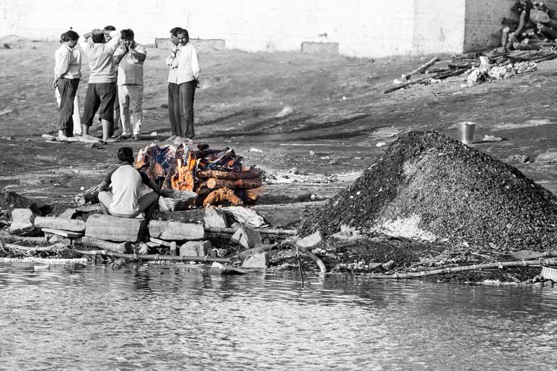 A dead body being cremated on the banks of river Ganga at Varanasi, Uttar Pradesh, adding to river pollution